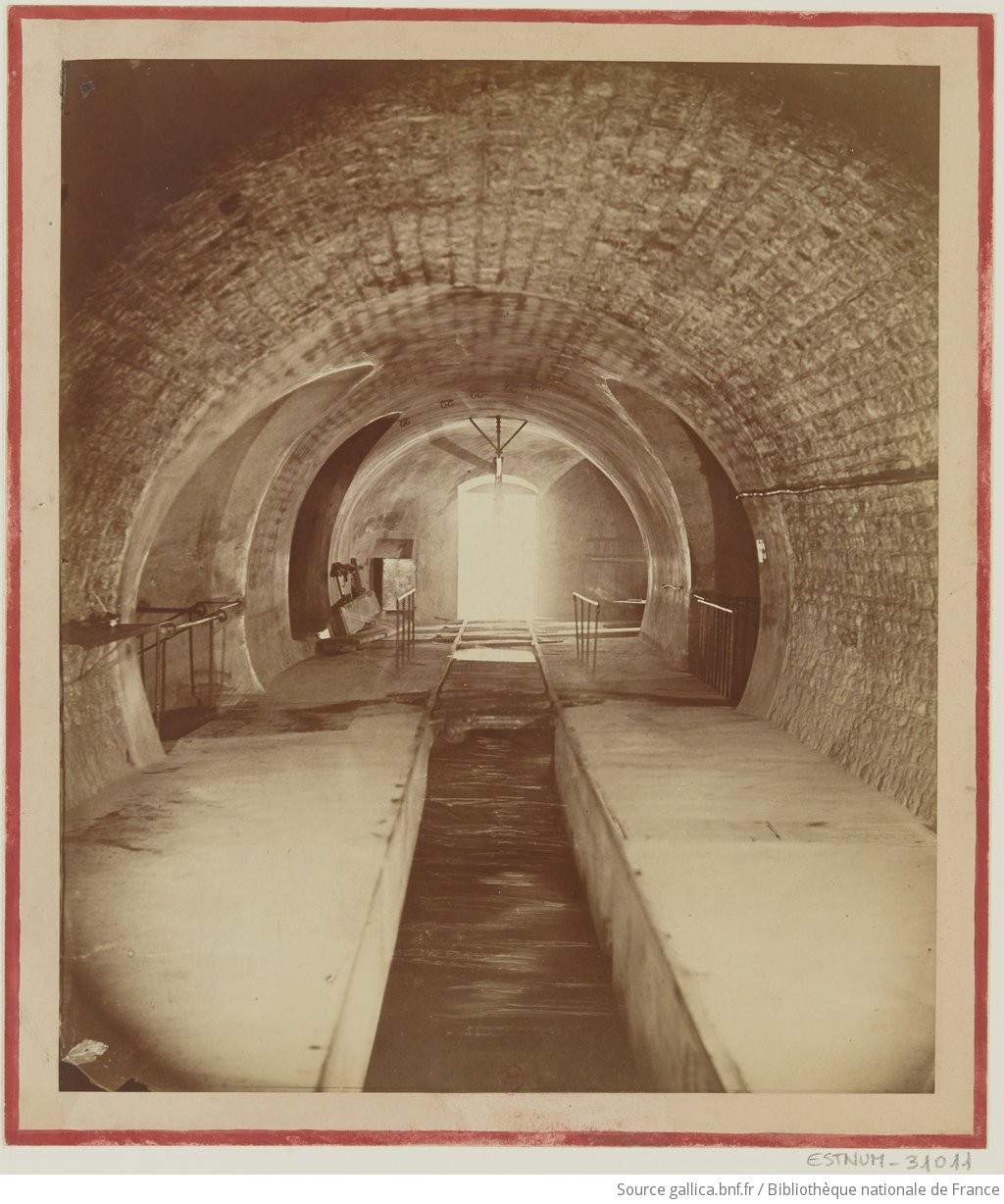 Félix Nadar, Égouts Paris France, éclusée n°2, ca. 1864-5 A 19th century, sepia-toned photo of the Paris sewers, a brick-lined tunnel