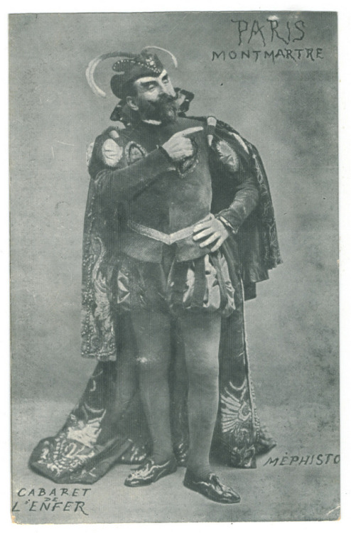 Antonin Alexander dans le rôle de Méphisto au Cabaret de l'Enfer An early 20th-century, black and white photo of Antonin Alexander in the role of Mephistopheles (or as Le Queux describes him, Satan). He wears horns on his head, an opulent cape, and lots of velvet.